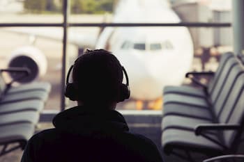 Traveler with noise cancelling headphones