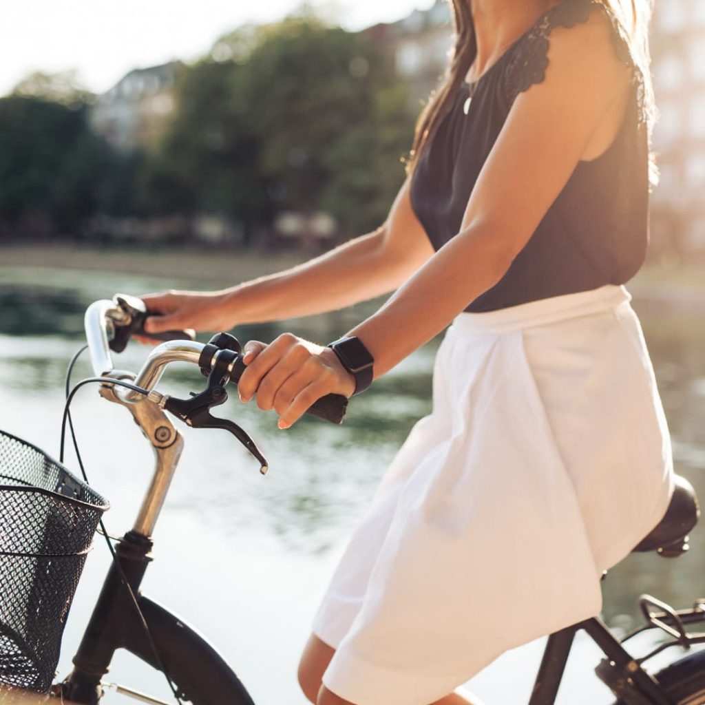 A Girl on a Bicycle with a Smart Watch